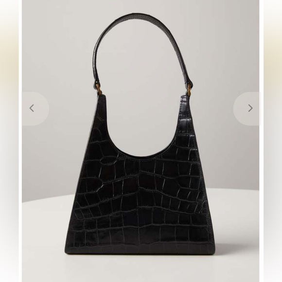 STAUD Handbags - The STAUD Rey Bag in black is a triangular leather bag featuring a top handle
